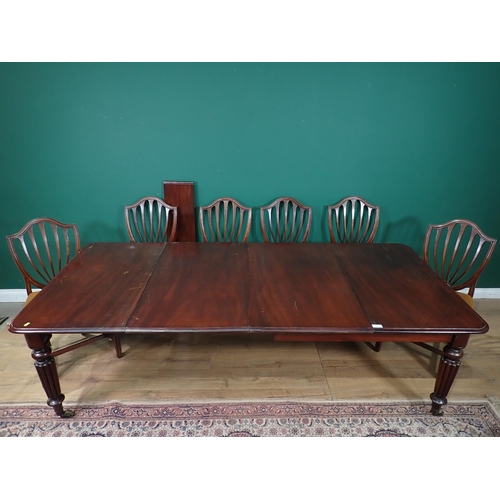 462 - A Victorian mahogany extending Dining Table with pull out action, and three spare leaves mounted upo... 