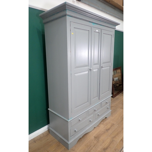 465 - A modern painted pine Wardrobe, the top section with pair of panelled doors, above the base fitted t... 