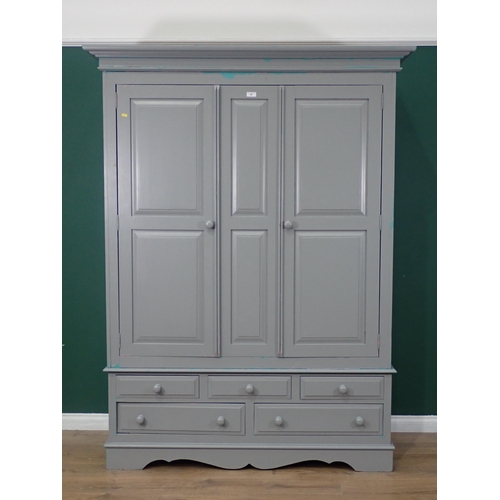 465 - A modern painted pine Wardrobe, the top section with pair of panelled doors, above the base fitted t... 