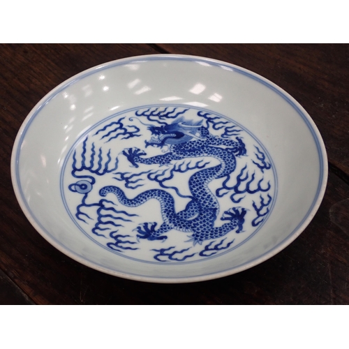 332 - A Chinese blue and white shallow Saucer Dish, painted dragon to centre and exterior, 6¾in, six chara... 