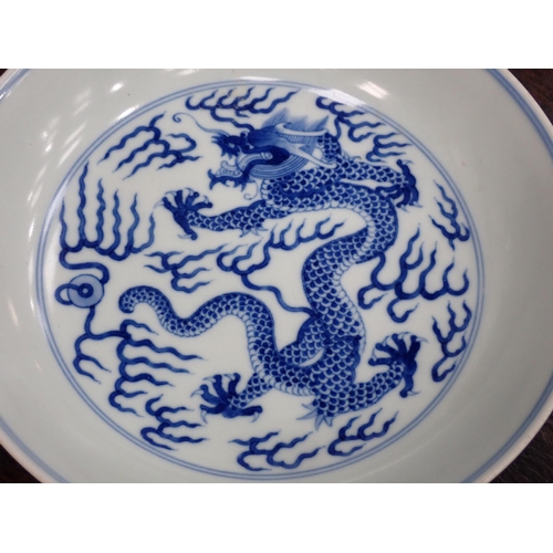 332 - A Chinese blue and white shallow Saucer Dish, painted dragon to centre and exterior, 6¾in, six chara... 