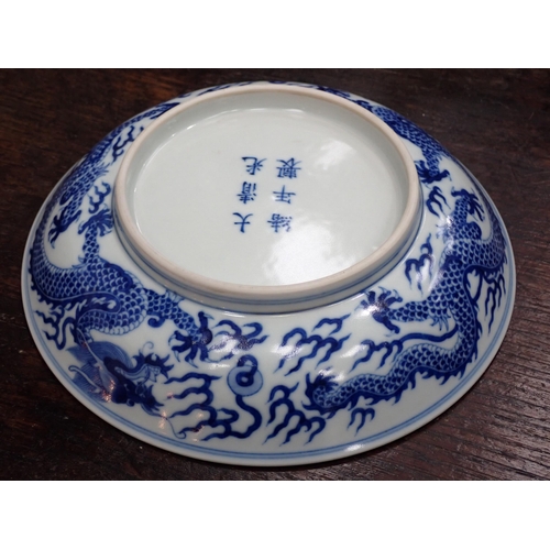 332 - A Chinese blue and white shallow Saucer Dish, painted dragon to centre and exterior, 6¾in, six chara... 