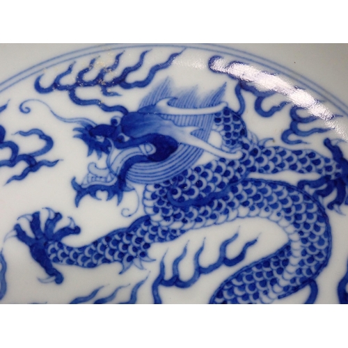 332 - A Chinese blue and white shallow Saucer Dish, painted dragon to centre and exterior, 6¾in, six chara... 