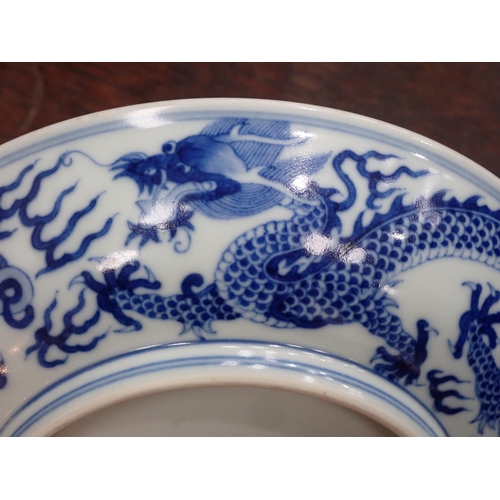 332 - A Chinese blue and white shallow Saucer Dish, painted dragon to centre and exterior, 6¾in, six chara... 