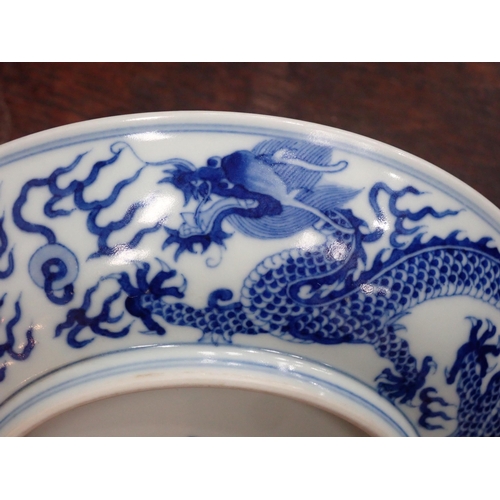 332 - A Chinese blue and white shallow Saucer Dish, painted dragon to centre and exterior, 6¾in, six chara... 