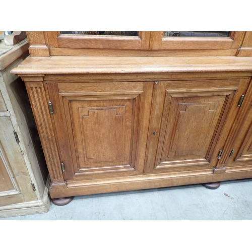 534 - A large French oak Bookcase, the upper section fitted four glazed doors enclosing adjustable shelves... 