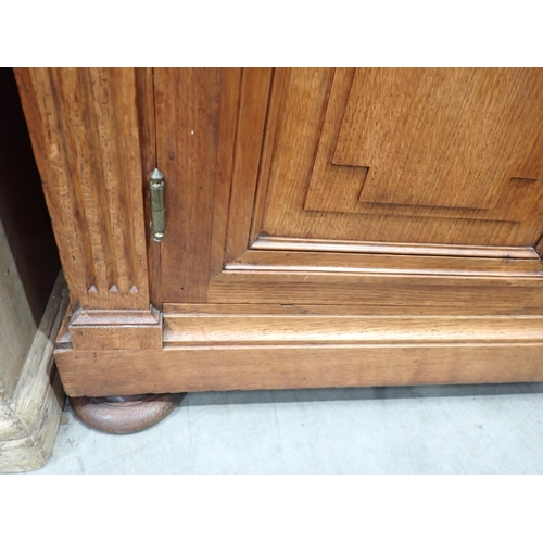 534 - A large French oak Bookcase, the upper section fitted four glazed doors enclosing adjustable shelves... 