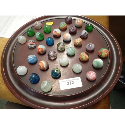 372 - A 19th Century mahogany circular Solitaire Board, 12in diam, and a collection of old coloured Marble... 