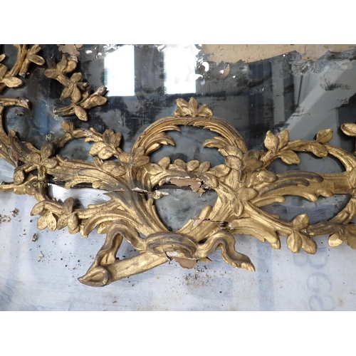 470 - An 18th Century giltwood framed Wall Mirror with circular leafage and pendant design, 4ft 3in x 2ft ... 