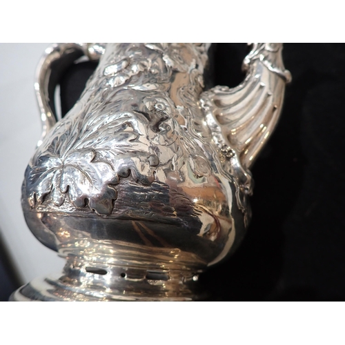 82 - A George IV silver Coffee Pot of pear shape with floral embossing, engraved crest, domed cover havin... 