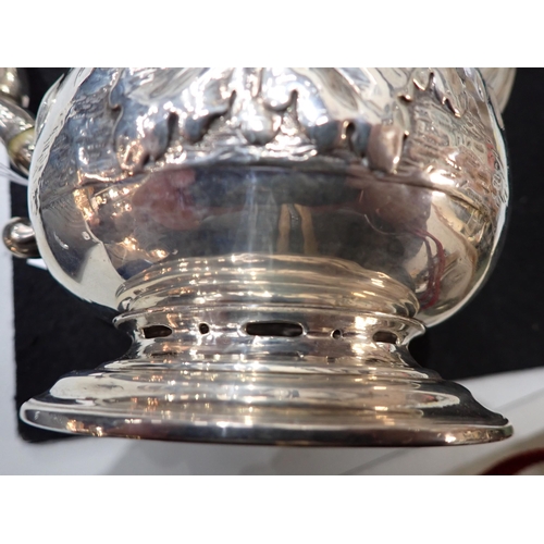 82 - A George IV silver Coffee Pot of pear shape with floral embossing, engraved crest, domed cover havin... 