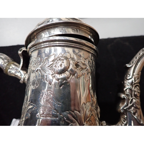 82 - A George IV silver Coffee Pot of pear shape with floral embossing, engraved crest, domed cover havin... 