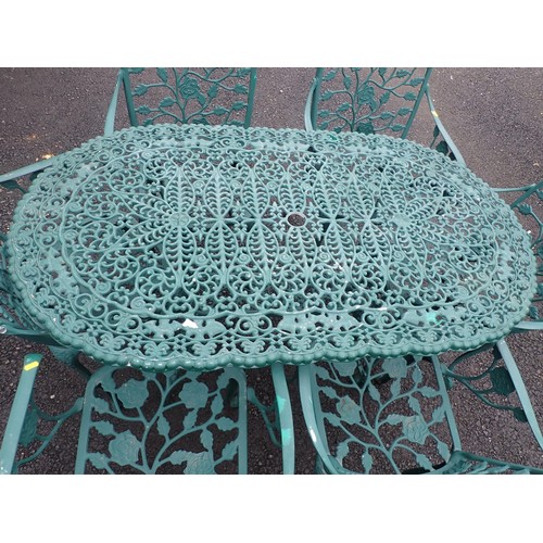 387 - A green painted metal Garden Table 4ft 7in W x 2ft 4in H and six Chairs with trailing rose back (one... 