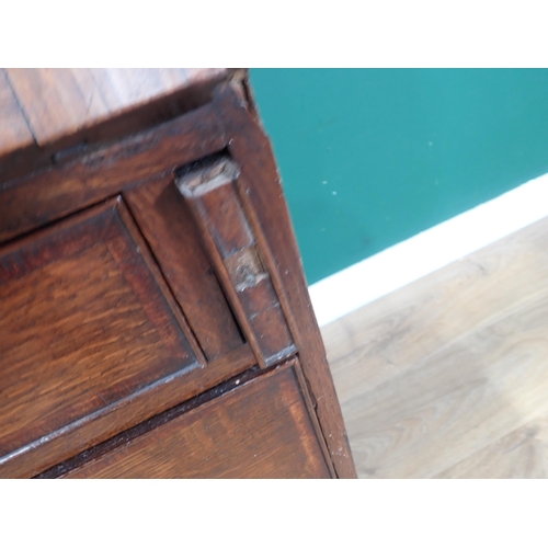 613 - A Georgian oak Bureau, the sloping front enclosing a fitted interior above three graduated drawers o... 