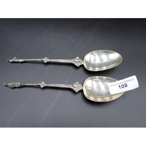 108 - A pair of Continental silver Apostle Spoons with mask stems, having figure finials