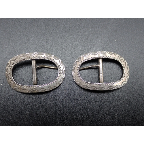 109 - A pair of Victorian silver small oval Buckles with bright cut engraving, Birmingham 1897, three Napk... 