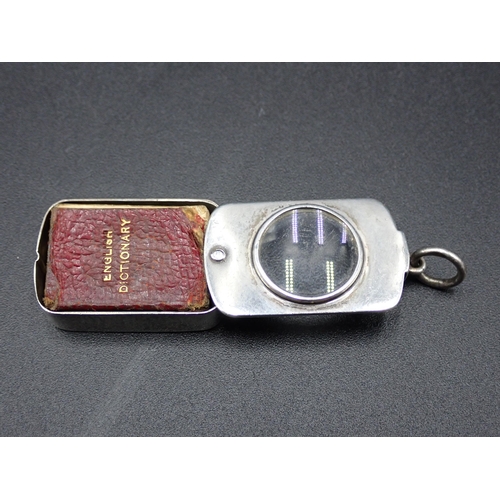 142 - A Victorian silver novelty Pendant Magnifying glass with swivel lid enclosing miniature Dictionary, ... 