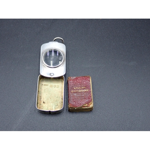 142 - A Victorian silver novelty Pendant Magnifying glass with swivel lid enclosing miniature Dictionary, ... 