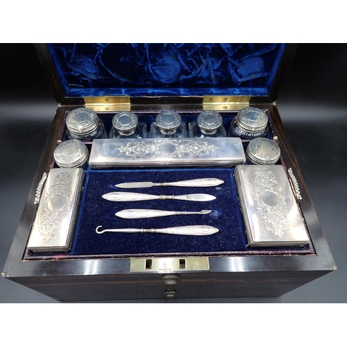 146 - A Victorian Coromandel Dressing Case containing silver lidded boxes and jars with finely engraved fl... 