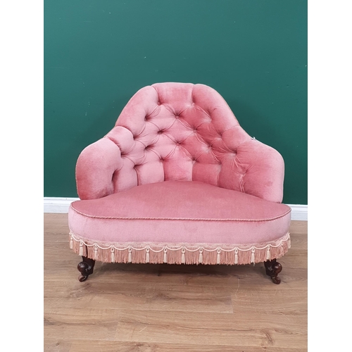 15 - A Victorian pink button upholstered Corner Chair with tassled fringe and raised on walnut scrolled f... 