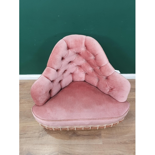 15 - A Victorian pink button upholstered Corner Chair with tassled fringe and raised on walnut scrolled f... 