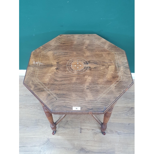 16 - An Edwardian rosewood octagonal Table with central floral inlay, raised on turned supports and caste... 