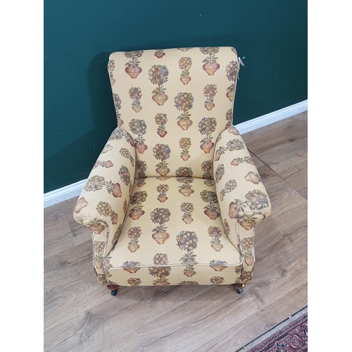 38 - A Victorian upholstered Armchair, raised on turned front supports and casters