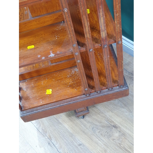 4 - An Edwardian Satinwood Revolving Bookcase with inlaid top on casters (A/F) 2ft 9