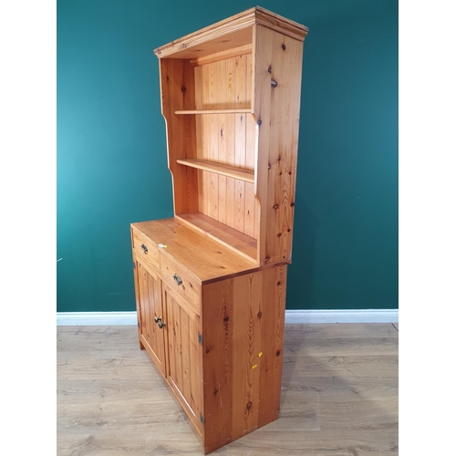 455 - A small pine Dresser and rack fitted drawers and cupboards, 5ft 11in H x 3ft W