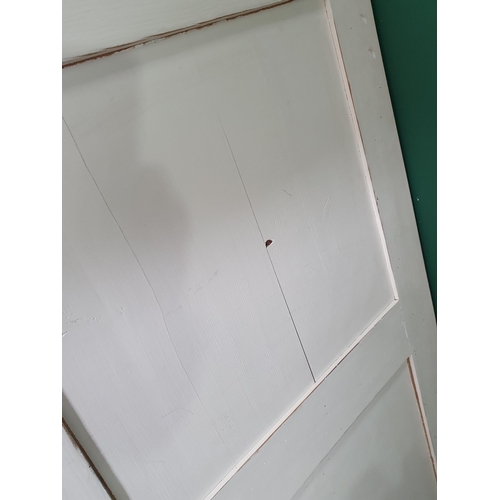 476 - A white painted pine triple door Wardrobe fitted drawers to base on turned supports, 6ft 10in H x 4f... 