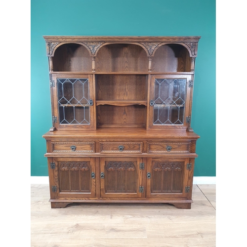 48 - An Old Charm oak Dresser and Rack fitted a pair of leaded glass doors above drawers and cupboards, 5... 