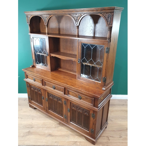 48 - An Old Charm oak Dresser and Rack fitted a pair of leaded glass doors above drawers and cupboards, 5... 