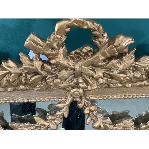 540 - A reproduction rectangular Wall Mirror with torch surmount and swag decoration