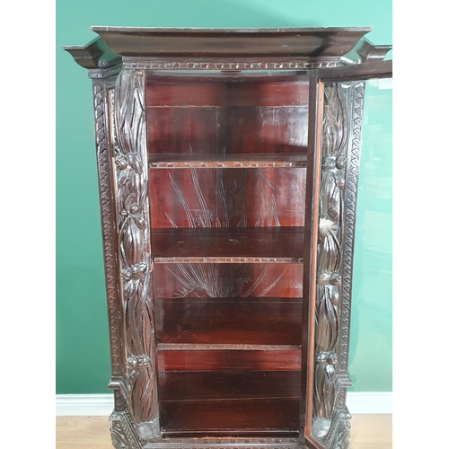 550 - An ebonised Display Cabinet with carved floral decoration and canted corners 5ft 4in H x 3ft 4in W