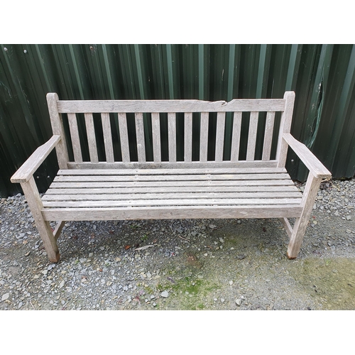 57 - A teak Garden Bench by Barlow Tyrie with slatted divisions, 5ft, top rail damaged