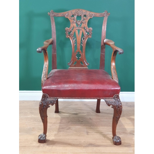 571 - A Georgian style mahogany Elbow Chair on carved cabriole supports and claw and ball feet, with exten... 