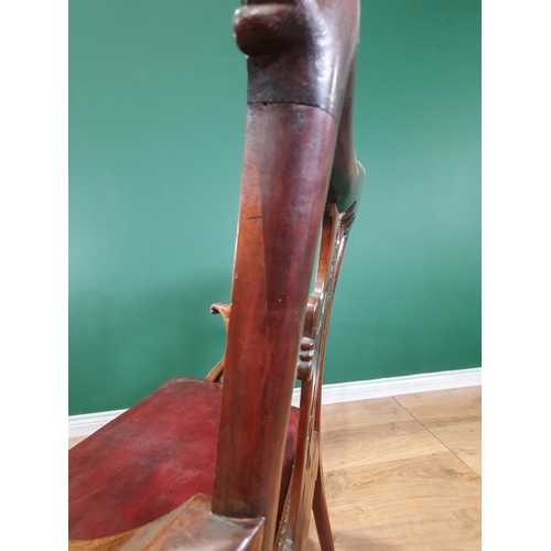 571 - A Georgian style mahogany Elbow Chair on carved cabriole supports and claw and ball feet, with exten... 