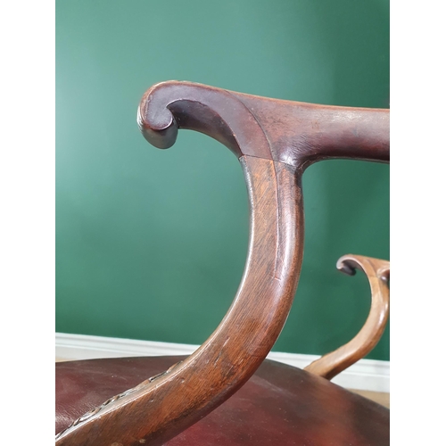 571 - A Georgian style mahogany Elbow Chair on carved cabriole supports and claw and ball feet, with exten... 