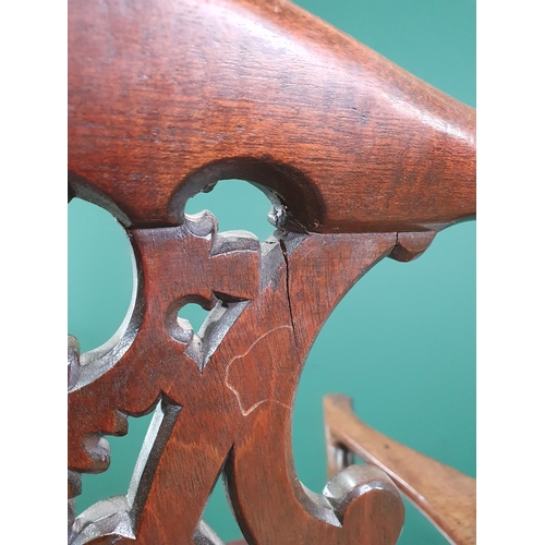 571 - A Georgian style mahogany Elbow Chair on carved cabriole supports and claw and ball feet, with exten... 