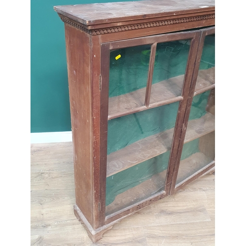 574 - A mahogany and glazed two door Bookcase on bracket feet 4ft 3in H x 4ft 1in W