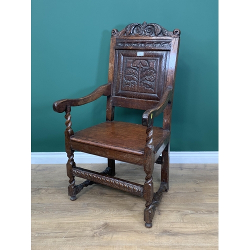 580 - An oak Elbow Chair with carved panel back in the 17th Century style 3ft 8in H x 1ft 11in W