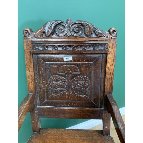 580 - An oak Elbow Chair with carved panel back in the 17th Century style 3ft 8in H x 1ft 11in W