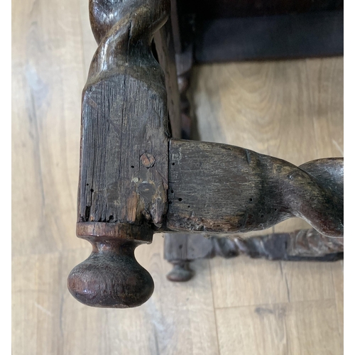 580 - An oak Elbow Chair with carved panel back in the 17th Century style 3ft 8in H x 1ft 11in W