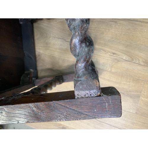 580 - An oak Elbow Chair with carved panel back in the 17th Century style 3ft 8in H x 1ft 11in W