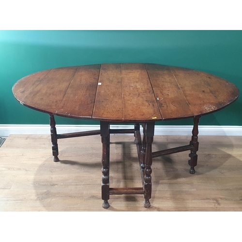 615 - An antique oak Gateleg Dining Table on baluster turned supports 4ft 4in W x 2ft 5in H