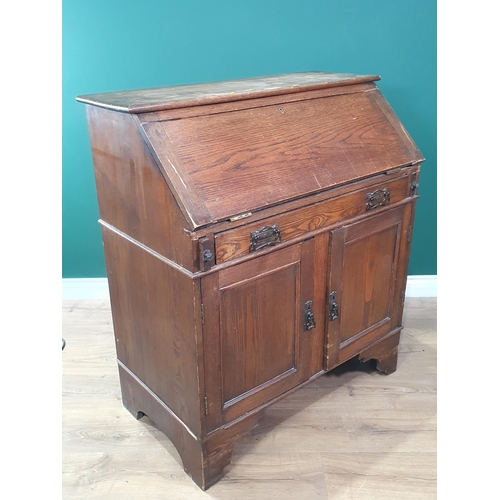 632 - An oak Bureau fitted single drawer above two cupboard doors 3ft 4in H x 2ft 11in W