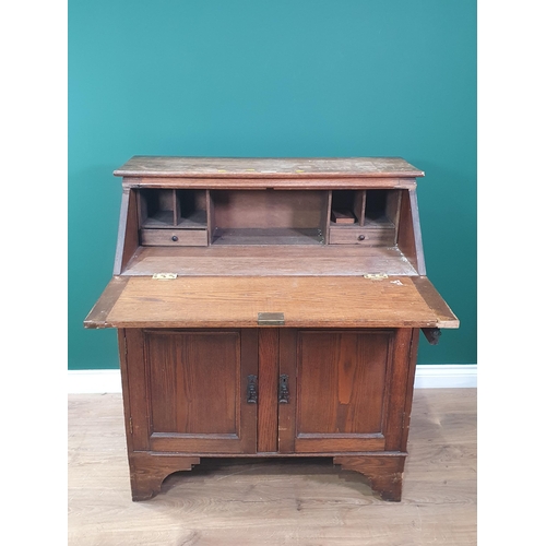 632 - An oak Bureau fitted single drawer above two cupboard doors 3ft 4in H x 2ft 11in W