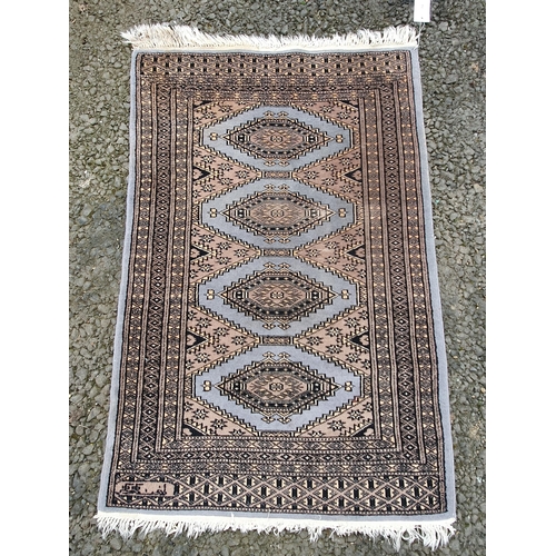 64 - Two small Persian style Rugs with stylised guls on a brown, blue and red ground, 3ft 2in x 2ft 2in