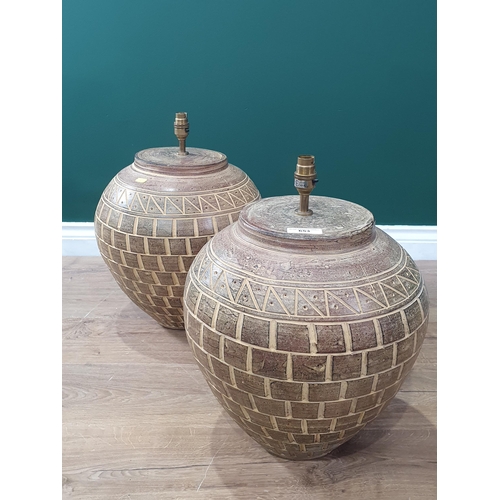 653 - A pair of earthenware Table Lamps with incised decoration 1ft 6in H. Failed PAT, loose fitting