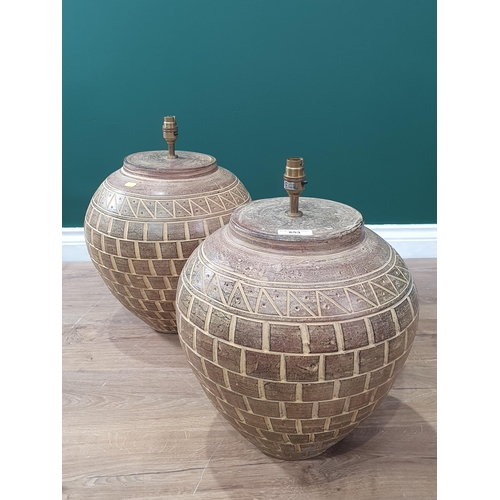 653 - A pair of earthenware Table Lamps with incised decoration 1ft 6in H. Failed PAT, loose fitting